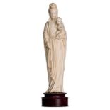 A Chinese ivory sculpture depicting the Virgin and Child, first half of the 20thC, on a wooden base,