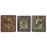 Three East European 19th / 20thC icons, set with a silver plated and gilt metal reza, 30 x 34 - 33,5