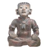 A statue of a sitting man referring to the Pre-Columbian art, polychrome cold painted terracotta,