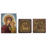 A 19thC East European icon depicting the Holy Mother and Child; added two framed icons with gilt and