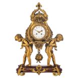 A rare French Rococo style mantle clock, gilt bronze and a rouge impérial marble base, the clock