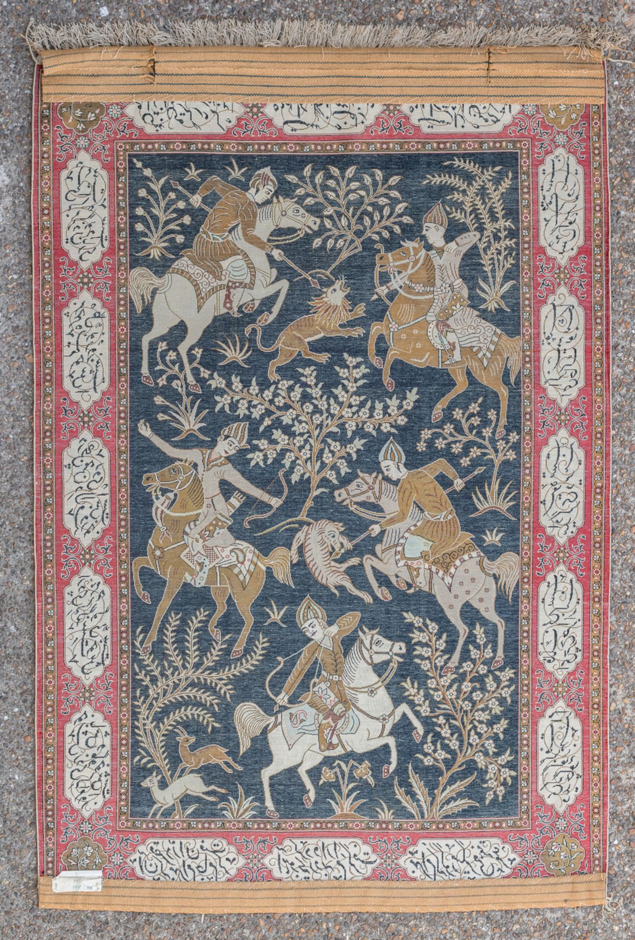 An Oriental silk carpet decorated with a hunting scene, the roundels with calligraphic inscriptions, - Image 2 of 3