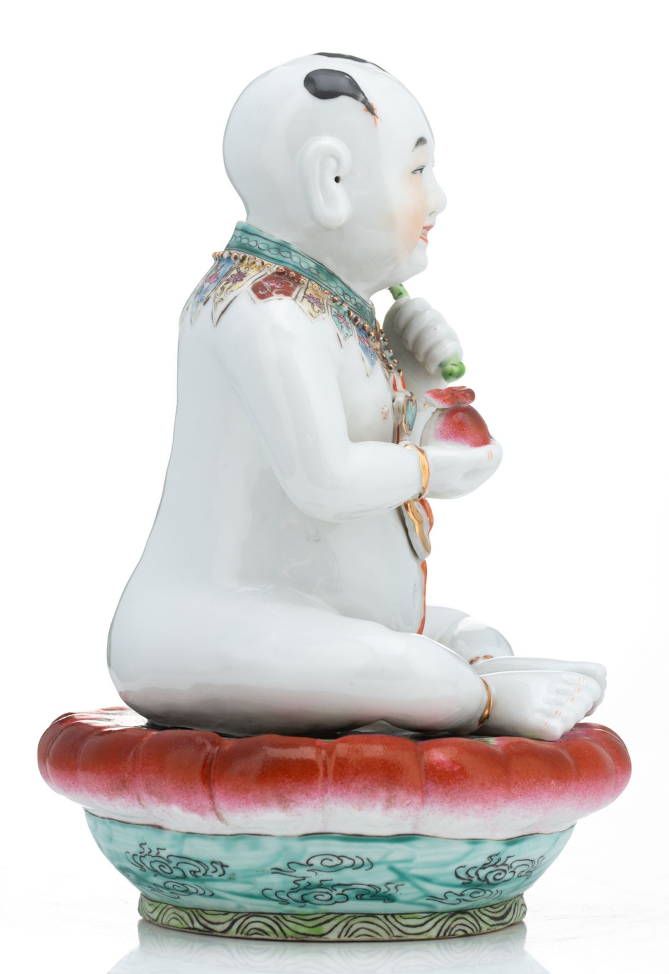 A Chinese famille rose figure of a young Buddha, seated on a lotus base; added a Chinese celadon - Image 11 of 13