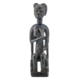 An African wooden sculpture depicting a seated female figure, Hemba - Congo, H 53,5 cm