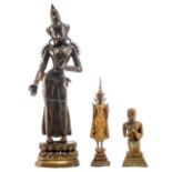 Two gilt bronze statues, one of which a praying Buddha and one of which a standing Buddha,