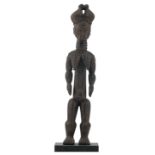 An African wooden sculpture depicting a standing female figure, Attie - Ivory Coast, H 57,5 cm