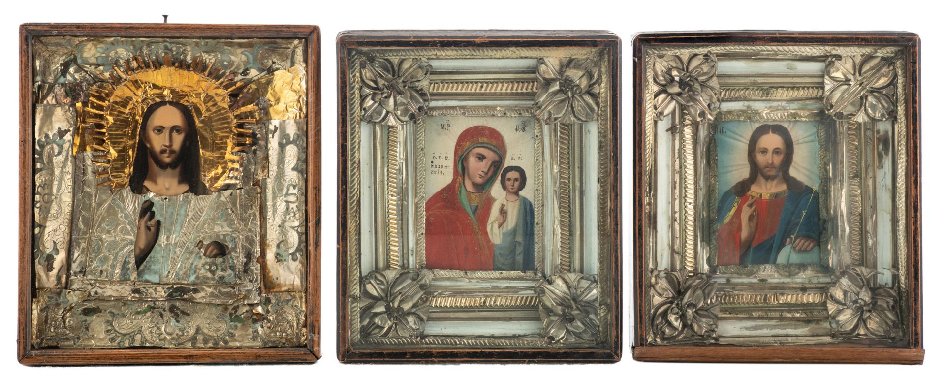 Three East European 19th / 20thC icons, set with a silver plated and gilt metal reza, 31 x 35 cm