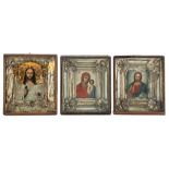 Three East European 19th / 20thC icons, set with a silver plated and gilt metal reza, 31 x 35 cm