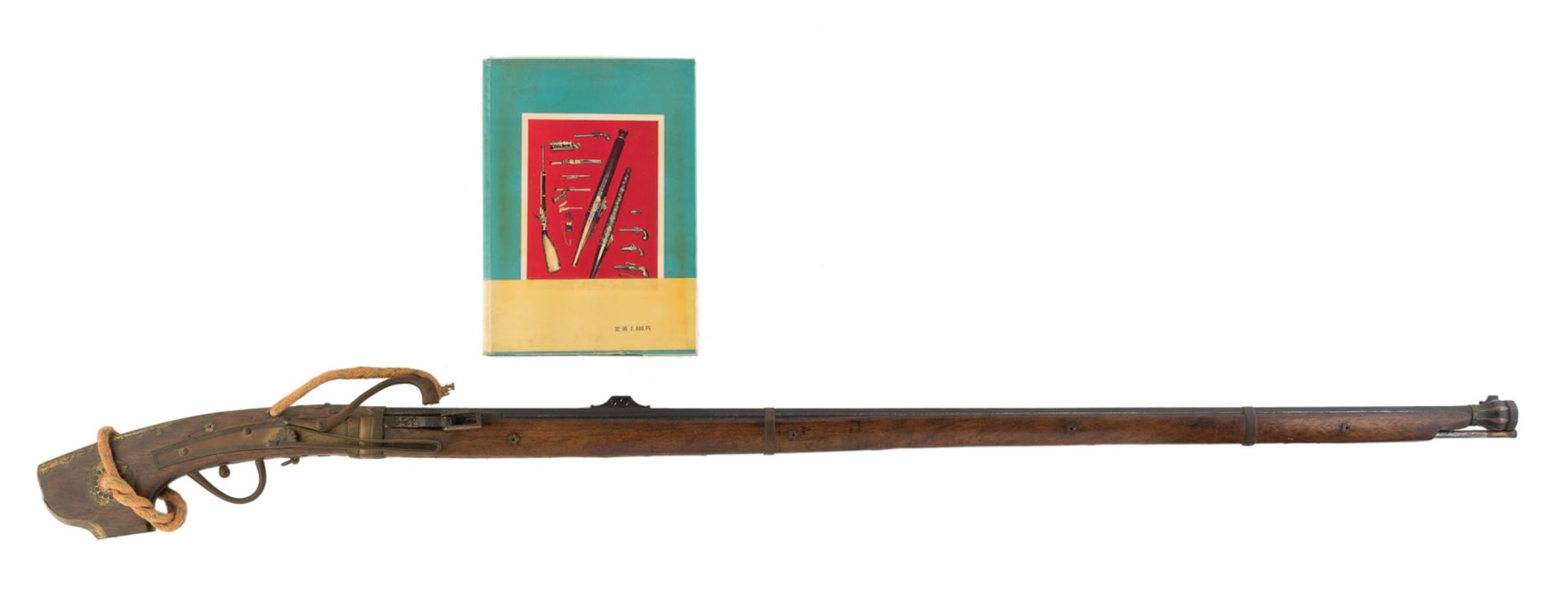 A Japanese possibly 17th/18thC rifle, the butt of exotic hardwood with brass inlay as well with