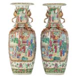 A pair of Chinese famille rose and dragon relief decorated Canton vases, the roundels with court