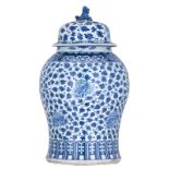 A large Chinese blue and white Kangxi vase and cover, decorated with scrolling peonies and bamboo,