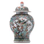 A Chinese famille verte floral decorated vase and cover, the roundels with birds, fish and