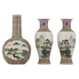 A Chinese famille rose floral decorated bottle vase, the roundels with figures and a pagoda in a