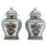 A pair of Chinese famille verte floral decorated vases and covers, the roundels with flower baskets,