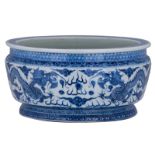 A Chinese pale celadon ground blue and white basin, overall decorated with dragons chasing the