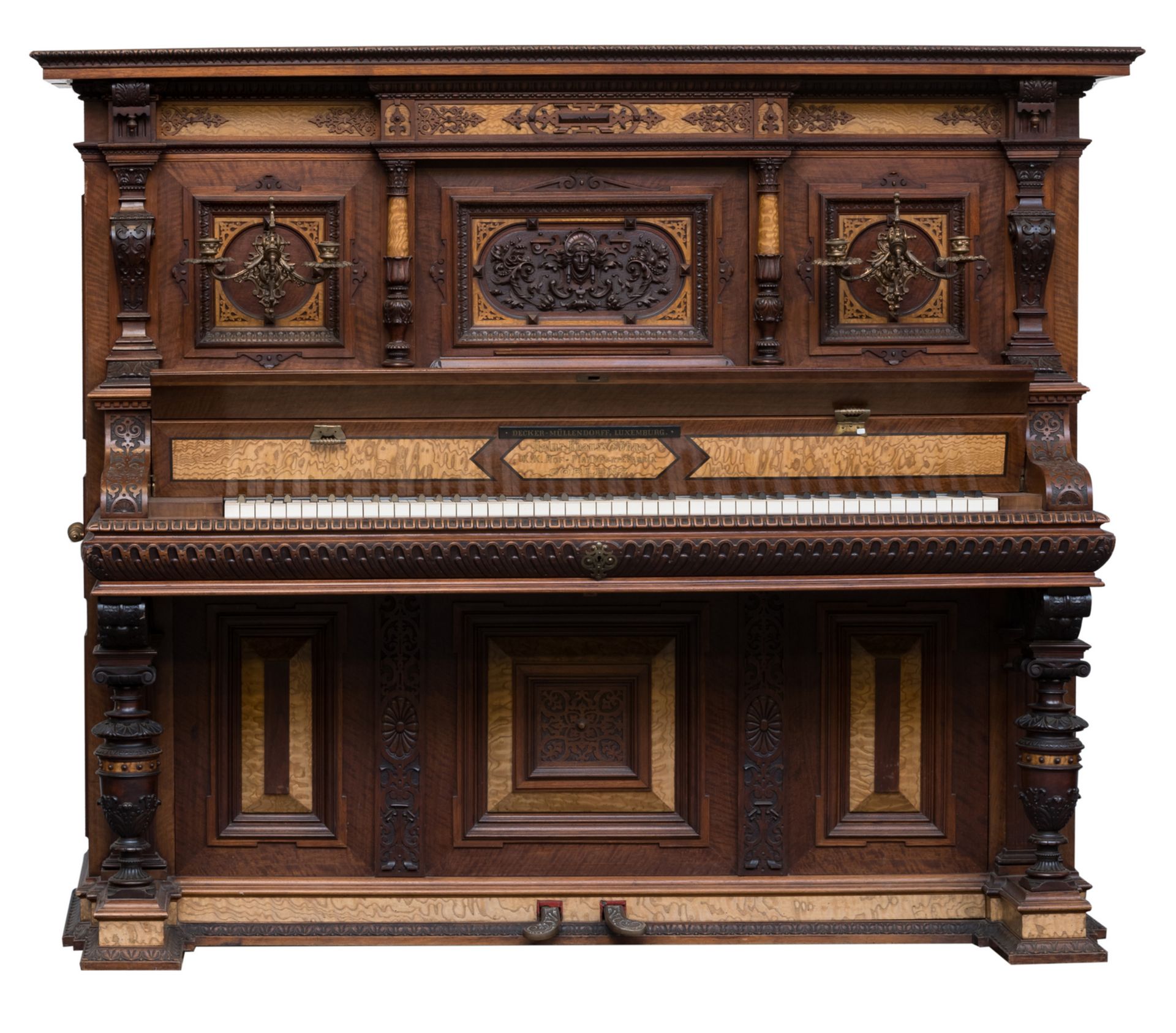 A fine richely carved american walnut and sicamore upright concert piano, Knauss, Coblenz