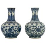 Two Chinese blue and white floral decorated bottle vases, with a Tongzhi mark, H 34 cm