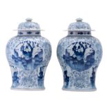 A pair of Chinese blue and white floral decorated vases and covers, the roundels with figures in a