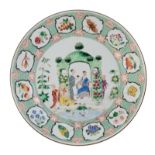 A Chinese famille rose export porcelain dish, the well decorated with an animated scene, depicting a