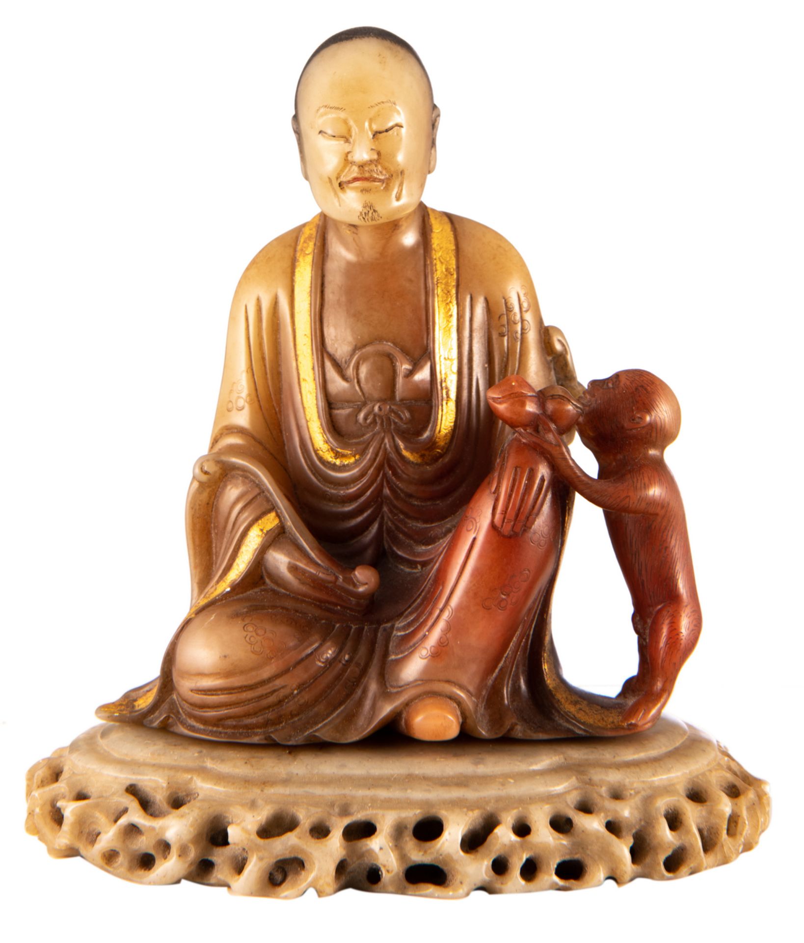 A Chinese polychrome and gilt decorated Shoushan stone figure depicting a Lohan Buddha and a monkey,