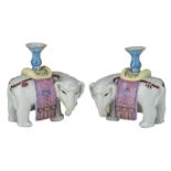 A pair of Chinese polychrome decorated elephant shaped stick holders, H 13 cm