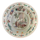 A large Chinese famille rose charger, decorated with literati, animated scenes and auspicious