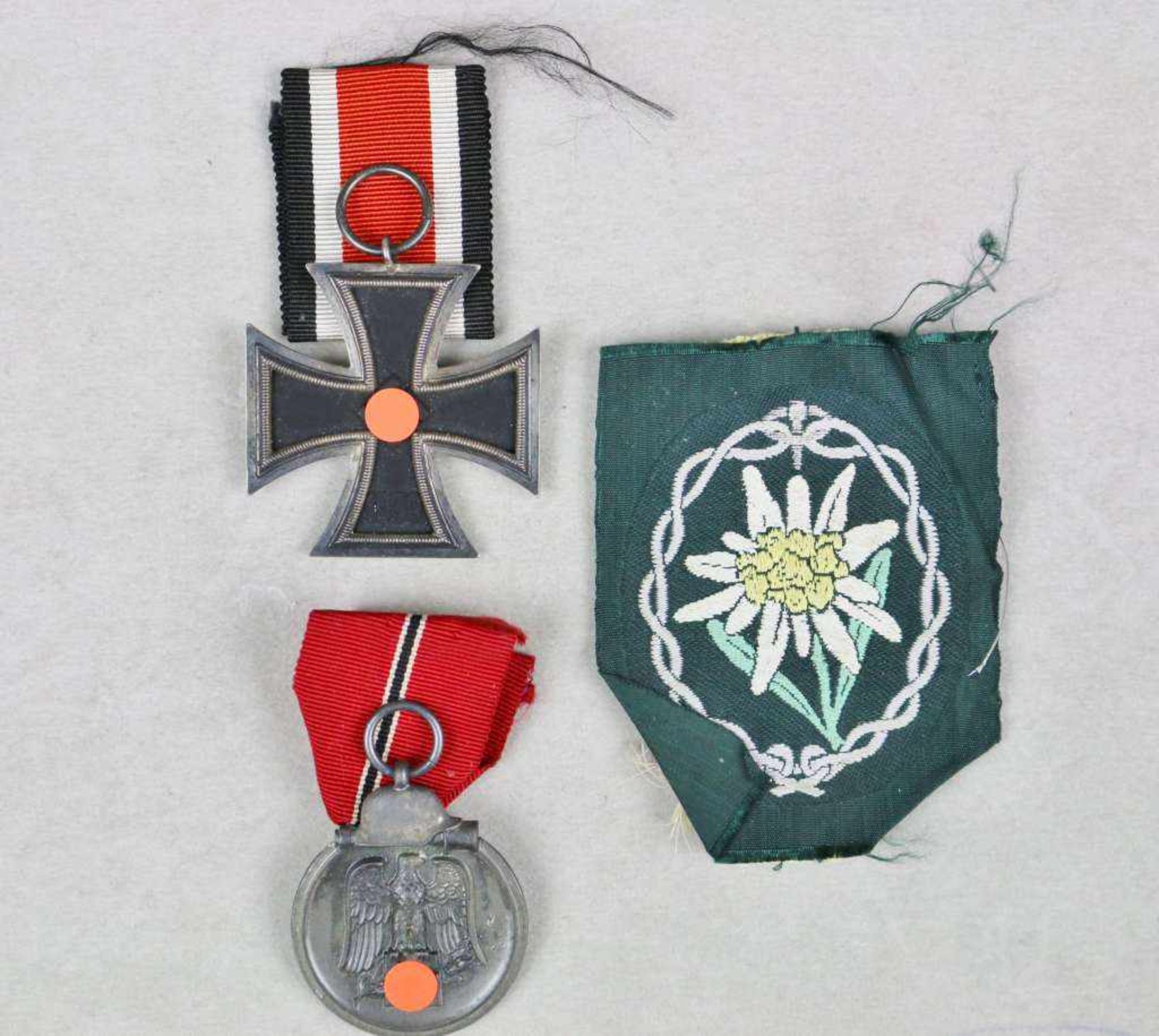 Eisernes Kreuz 2. Klasse 1939 am Band, Ostmedaille sowie Stoffabzeichen der Gebirgsjäger.