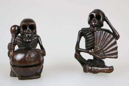 NETSUKE PAAR SKELETTIERTE FIGUREN, signiert, Holz, lasiert. H. 4,5 cm u. 5 cm.