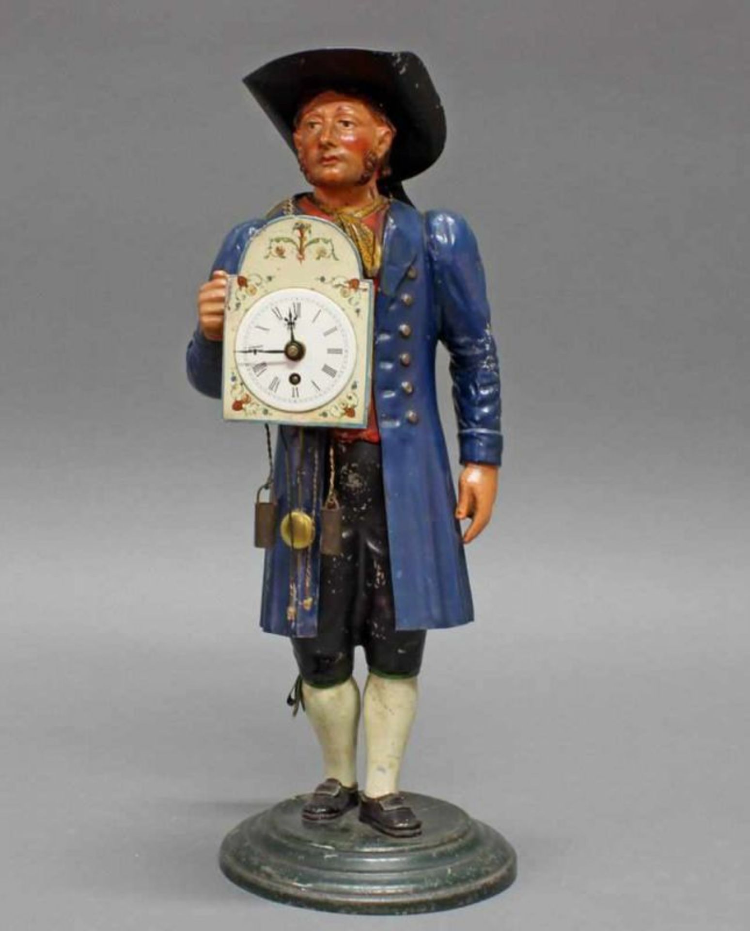 Figurenuhr, "Schwarzwälder Uhrenverkäufer", 19./20. Jh., Metallblech, polychrom, 36 cm hoch, stärker