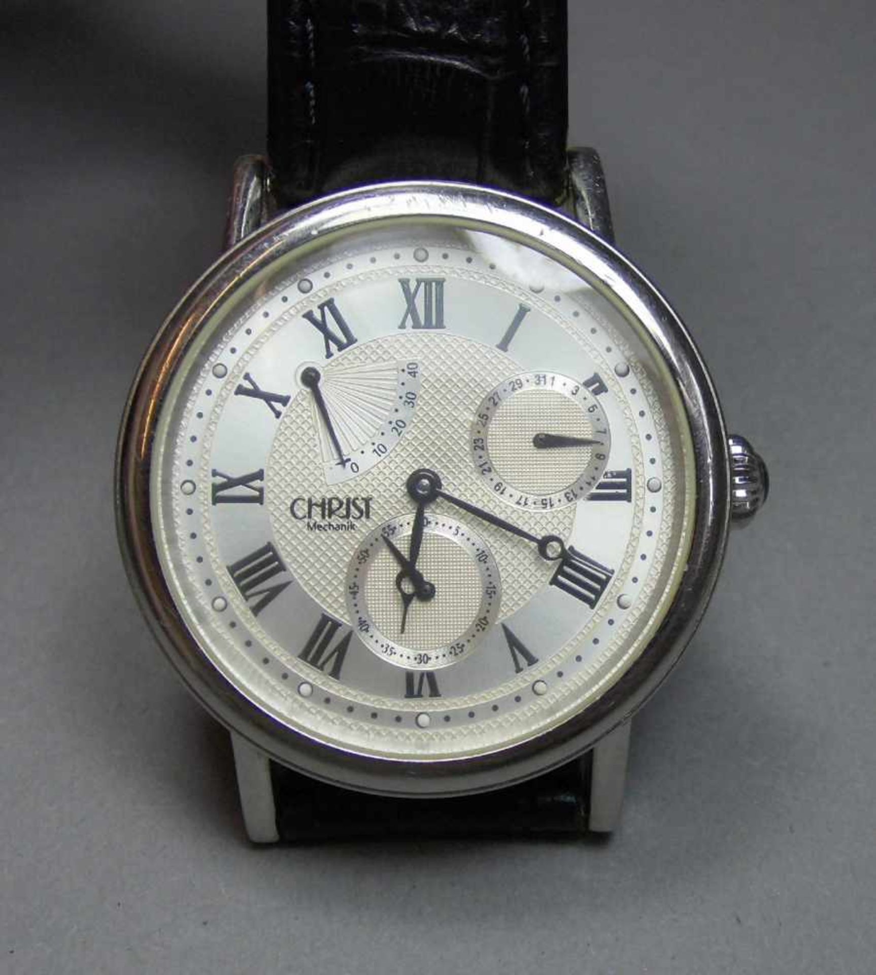 ARMBANDUHR / wristwatch, Juwelier Christ / Deutschland. Rundes Edelstahlgehäuse mit Glasboden und
