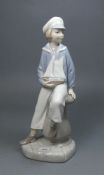 PORZELLAN - FIGUR: "Knabe mit Segelschiff", Manufaktur Lladro, Spanien. Knabe im Matrosenanzug auf