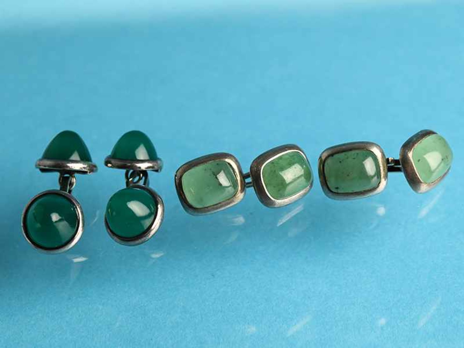 2 verschiedene Paar Manschettenknöpfe mit Jade- und Achat-Cabochon, Goldschmiedearbeit, 20. Jh.