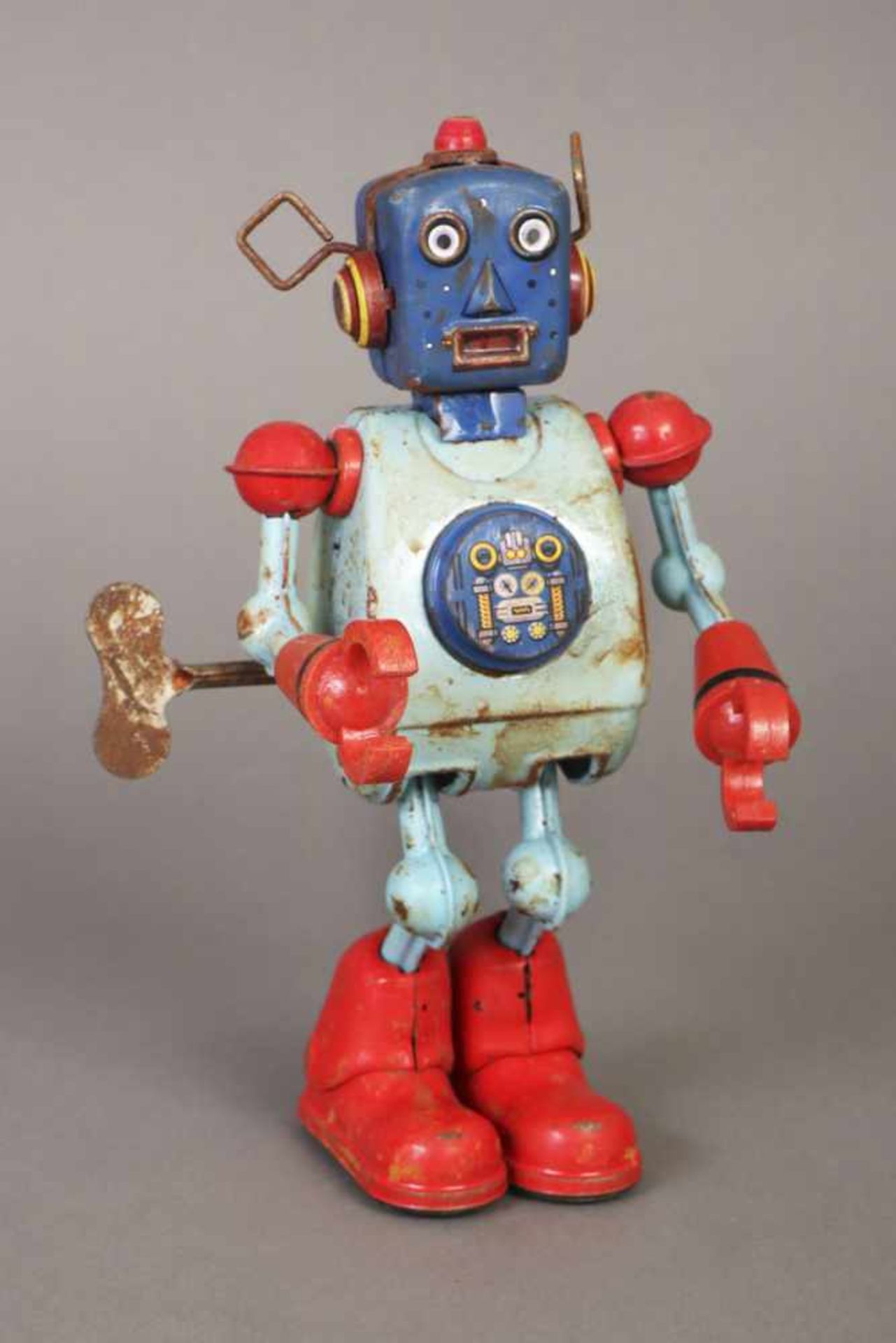Blechspielzeug ¨Roboter¨farbig staffiertes Metall und roter Kunststoff, Federwerk mit