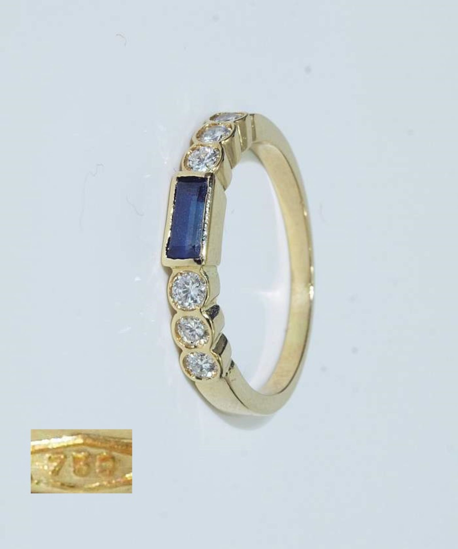 Damenring. Damenring. 750er Gelbgold, besetzt mit 6 Brillanten ca. 0,18 ct H/si und 1 Saphir,