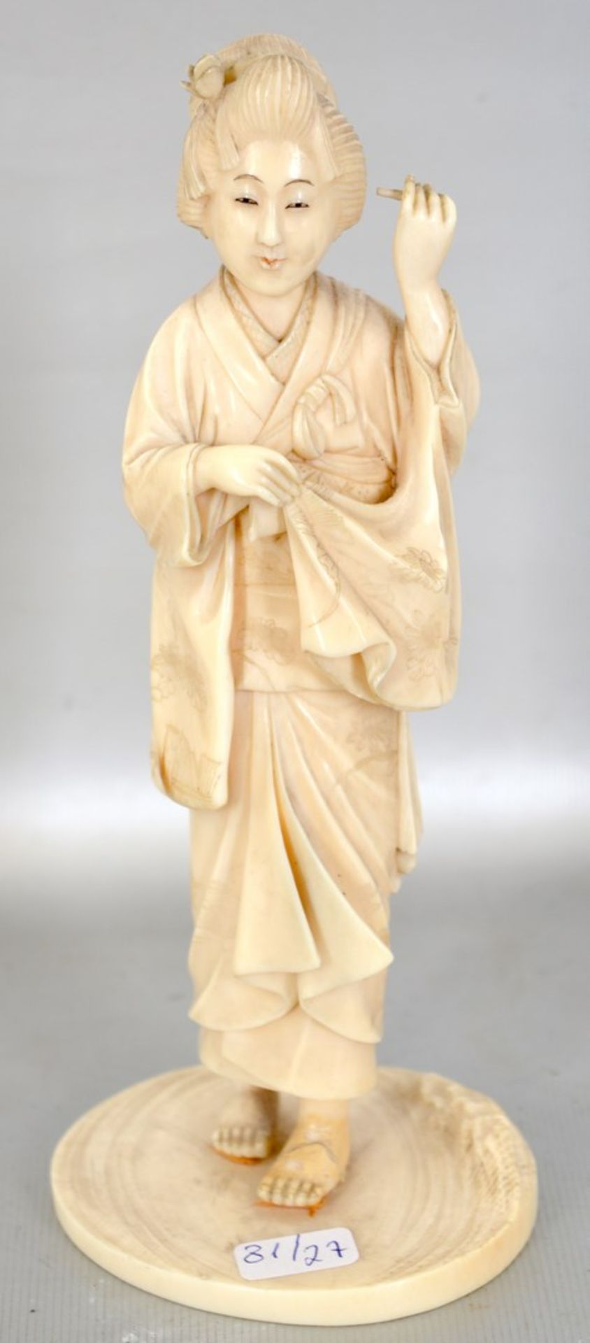 Geisha Bein, geschnitzt, auf rundem Sockel stehend, besch., H 18 cm, 19. Jh.