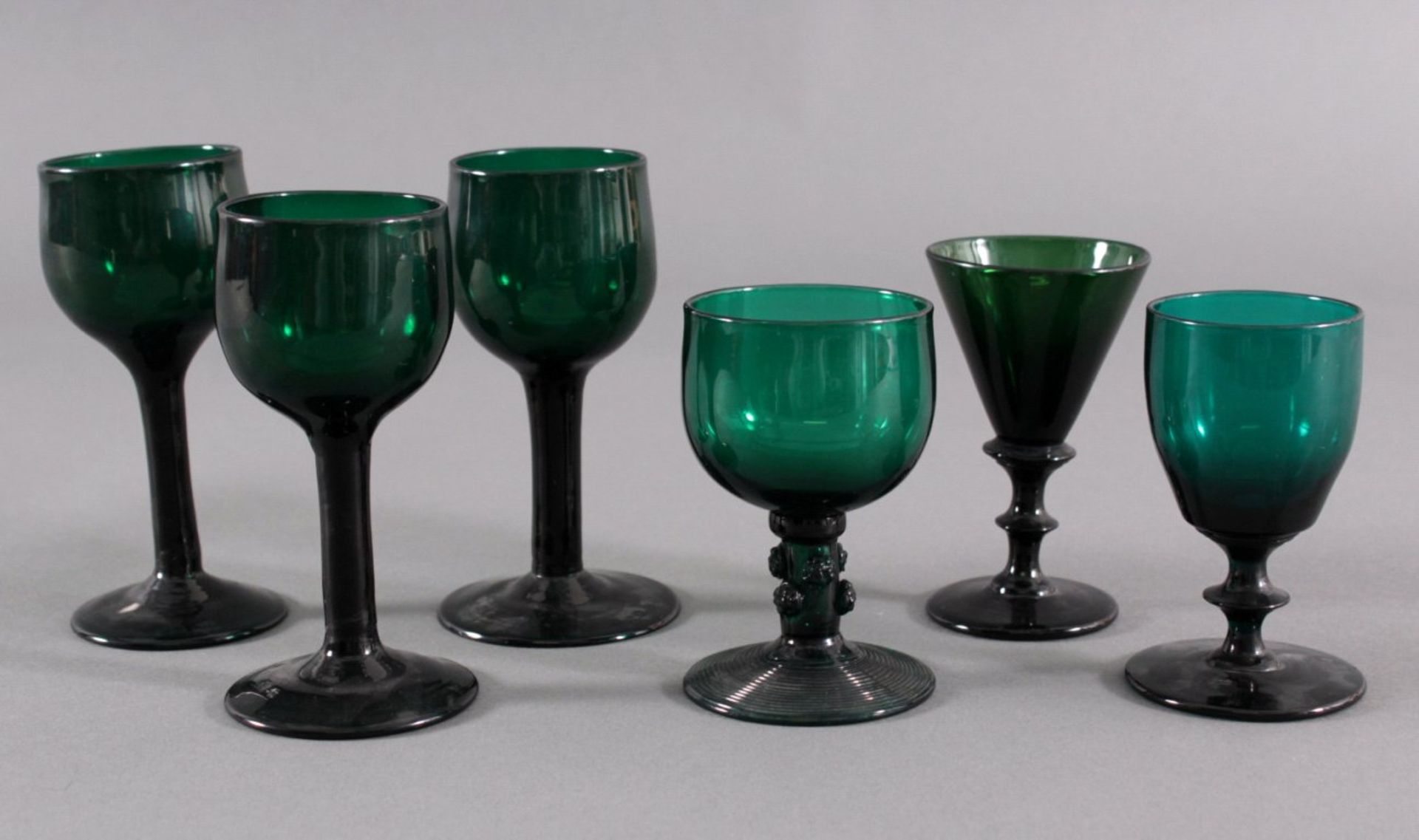 Sechs Gläser, Waldglas 19. Jh.Waldglas in Grüntönen. 1 mit aus Glasfäden gewickelter Fuss,Schaft mit