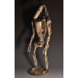 Movie Props - a one-off metal sculpture, of a Star Wars Droid soldier, standing, circular base,