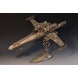 Movie Props - a one-off metal sculpture, of a Star Wars X Wing Fighter, mounted in flight,