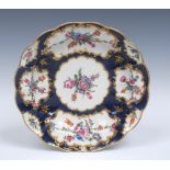 A Worcester large fluted shaped circular dish, decorated with colourful flowers,