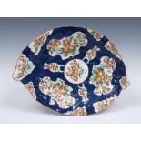 A Worcester Cabbage Leaf dish, moulded in relief with two overlapping cabbage leaves, stalk handle,