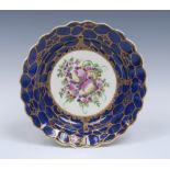 A Worcester shaped circular plate, painted in the atelier of James Giles,