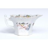 A Worcester hexagonal moulded cream boat, painted with colourful standing song bird,