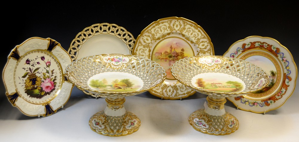 A pair of Minton pedestal comports, the fields painted with British scenery,