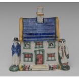 A Pratt Ware cottage money bank, with tiled cobalt blue roof,