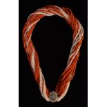 A seed pearl and coral bead multi strand necklace, sixteen spiral entwined strands,