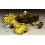 A pair of Arts and Craft curtain pole holders, brass bosses enamelled in black with fretwork,