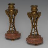 A pair of 19th century ormolu and rose marble candlesticks,