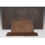 A set of four late 17th century oak rectangular panels, carved in relief with stylised tulips,