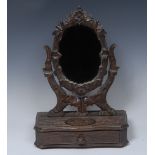 A Black Forest dressing table mirror, oval plate, the canted base with long drawer,