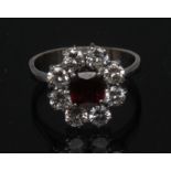 A diamond and ruby cluster ring, central oval ruby approx 0.